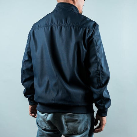 Man wearing a navy sports jacket from behind