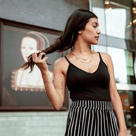woman wearing striped skirt and black tank top
