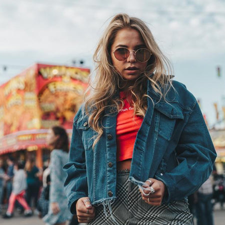 Woman wearing a denim jacket at an amusement park